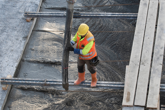 Worker applying crystallisation system for concrete waterproofing